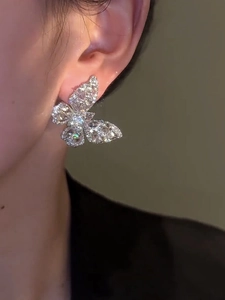 Macro side view of elegant silver butterfly earrings with sparkling cubic zirconia stones