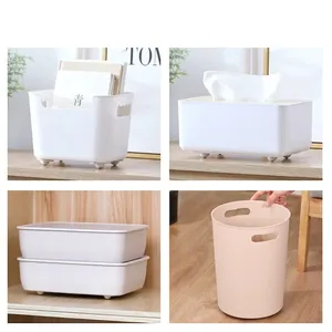 Modern white and pink storage boxes and trash bin with ergonomic handles for home organization