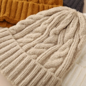 Thick cable-knit beanie hat in beige with wide ribbed cuff for winter warmth
