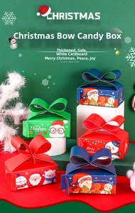 Close-up of festive Christmas candy boxes with 3D bows and Santa Claus illustrations