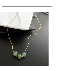 Detail showing high-quality gold titanium chain and green agate beads for women