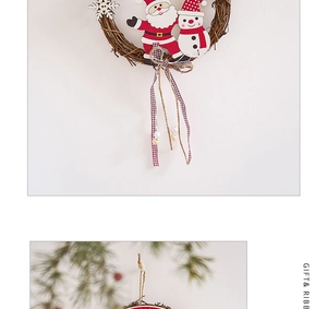 Detail of Christmas wreath with Santa and snowman pendants on a natural rattan ring