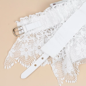 Detail of white lace waist belt with floral hollow pattern and golden metal buckle