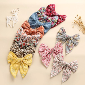 Flat lay of assorted cotton bow hair clips with floral, leopard and solid patterns
