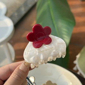 Elegant medium acetate hair claw with 3D red flower and white marble texture
