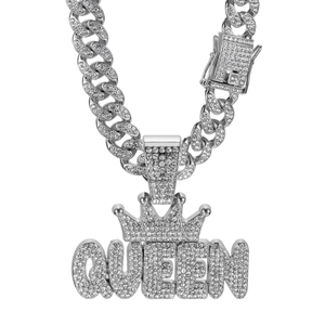 Close-up of iced out silver Queen crown pendant on a sparkling Cuban link chain