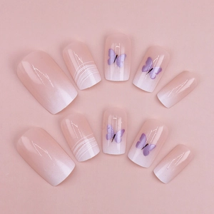 Pink and white ombre press-on nails featuring purple butterfly art and white line motifs