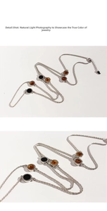 Detail shot of long silver twist chain with black enamel and brown tiger eye stone pendants