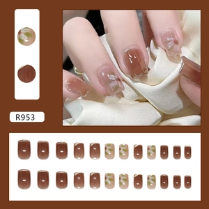 Elegant gold brown press-on nails with white flower designs and French gold edge finish