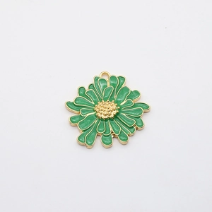 Detail of green enamel daisy charm with gold plated edges and center for DIY jewelry