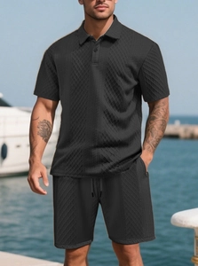 Close-up of black men's Polo set featuring 3D diamond texture and jacquard knit fabric