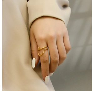 Close-up of 18K gold-plated double-layer ring with chain link detail on model's finger