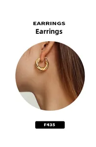 Detail of twisted rope gold hoop earrings worn on model for a minimalist style look