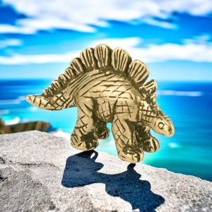 Detailed close-up of a bronze Stegosaurus figurine with vintage texture and back plates