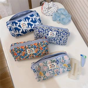 Detailed close-up of four floral canvas stationery pouches with sturdy metal zippers