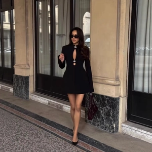 Elegant black bodycon mini dress with long sleeves and hollow-out metal buckle detail