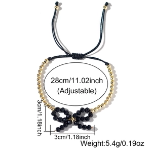 Bracciale regolabile nero con fiocco intrecciato e perline placcate in oro 18 carati