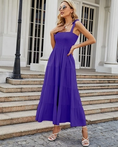 Detail showing elastic smocked bodice and tiered ruffle hem of a purple summer maxi dress