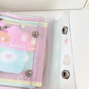 Close-up of pink and blue PVC binder covers with cute cartoon prints and metal snap buttons