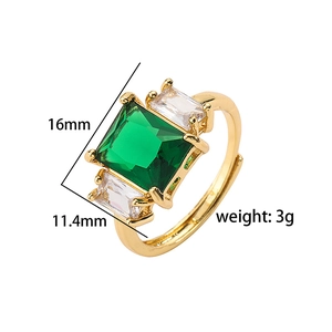 Detailed macro view of gold ring with emerald green stone and side zircon accents