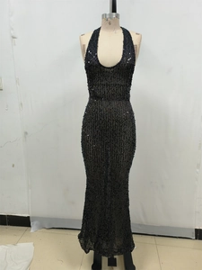 Detail of black sequined halter neck evening dress with deep V-neckline and open back