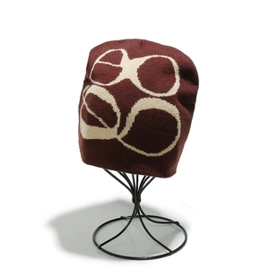 Detail of burgundy Y2K beanie featuring cream geometric knit jacquard texture