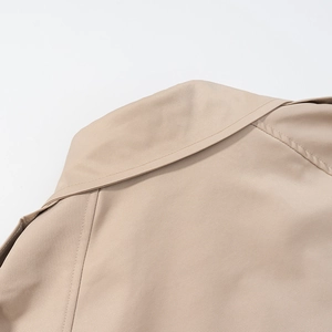 Close-up of khaki cropped jacket back collar with detailed twill texture and stitching
