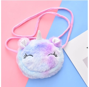 Detail of plush unicorn bag showing gradient fur and delicate eyelash embroidery