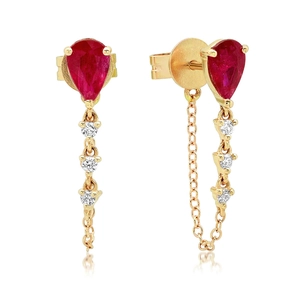 Detail of pear-shaped red gemstone earrings with dangling gold chain and white diamonds