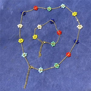 Golden chain jewelry set with colorful floral beads featuring a necklace and bracelet