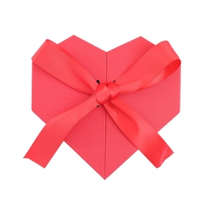 Elegant red heart-shaped gift box with a textured surface and large satin ribbon bow