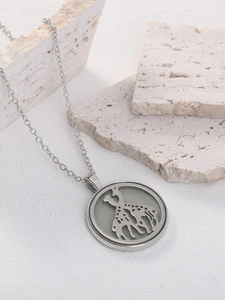 Close-up of silver giraffe silhouette pendant with hollow dots on cross chain