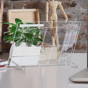 Detail of transparent acrylic weekly planner with floral patterns and metal stands