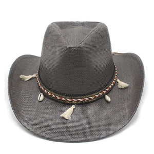 Detail of grey straw cowboy hat with colorful woven band, white tassels, and shells
