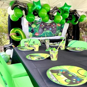 Gamer birthday party set with green balloon arch and game controller decorations