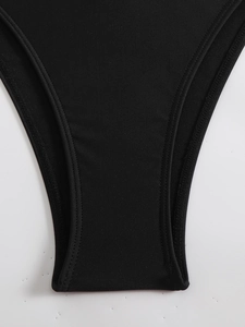 Close-up of black swimsuit crotch with premium elastic knit texture and double stitching