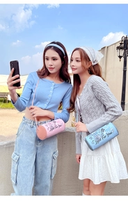 Close-up of stylish cylindrical crossbody bags with cute cartoon prints in pink and blue
