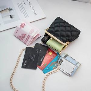 Black quilted mini crossbody bag with gold chain strap showing interior storage capacity