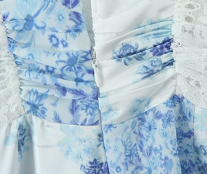 Detail of blue floral dress with white lace trim and invisible back zipper closure