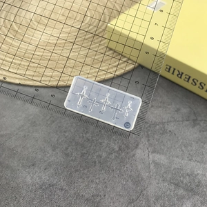 Detailed size view of transparent silicone mold for creating four cross-shaped pendants