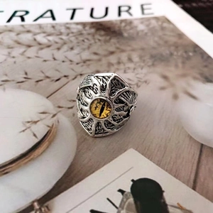 Detail of vintage punk evil eye ring in silver finish with yellow eye center stone