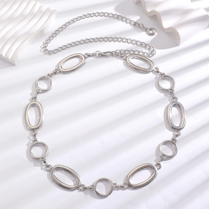 Macro detail of silver oval and round links on adjustable bohemian metal chain belt