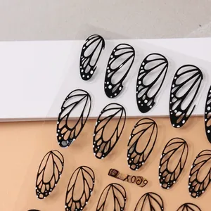 Detailed macro view of black butterfly wing nail art stickers with fine vein patterns