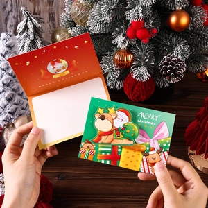 Close-up of colorful 3D Christmas cards with Santa Claus and reindeer illustrations