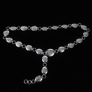 Detailed close-up of a silver metal waist chain featuring engraved sunflower pattern plates
