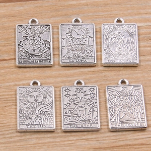 Set of six silver zinc alloy tarot card pendants with sun, moon, and star engravings