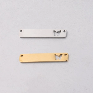Detailed view of rectangular steel butterfly connectors in gold and silver mirror finish