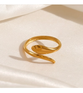 Macro detail of 18K gold plated snake ring showing smooth polished curves on white silk