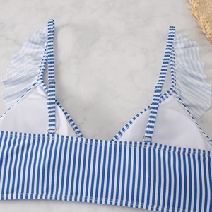 Detail of blue striped bikini top with ruffle straps and adjustable metal buckles