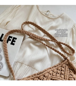 Detail of bohemian hollow knit cotton rope shoulder bag with sturdy woven strap